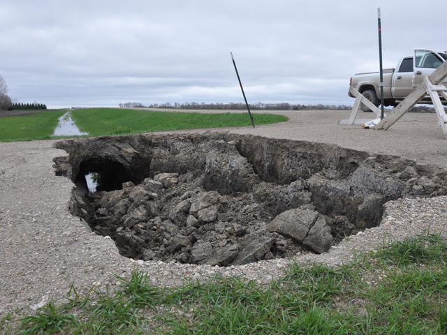 A sinkhole on a rural highway. Rural infrastructure is one of the areas facing funding shortfalls right now. The American Trucking Associations is pushing for higher federal fuel taxes to fund road and bridge improvements. (DTN file photo)